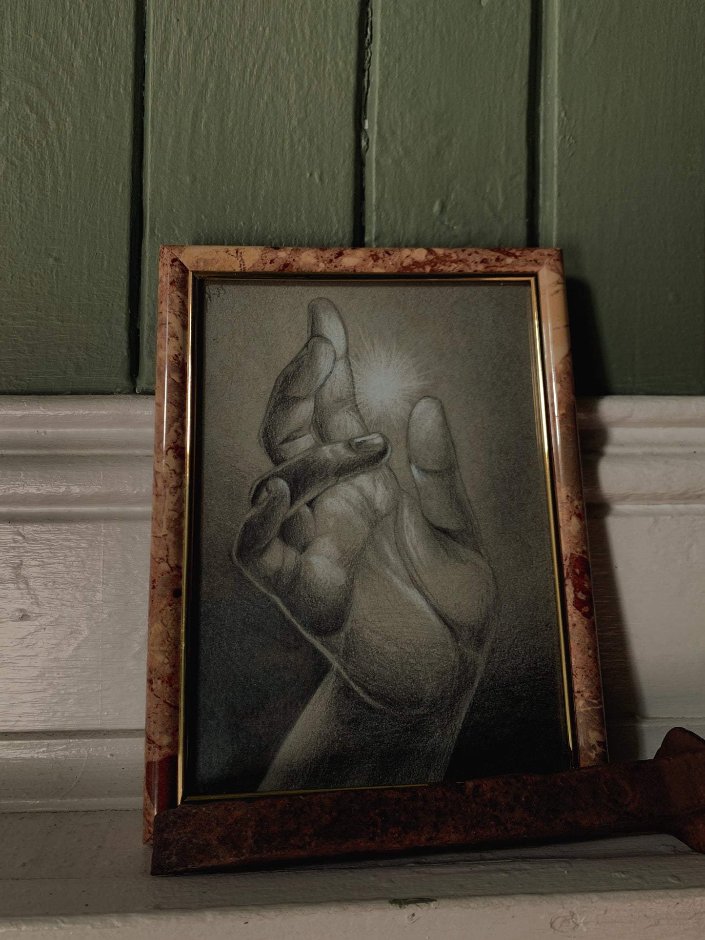 Graphite and chalk drawing of a sorcerer’s hand