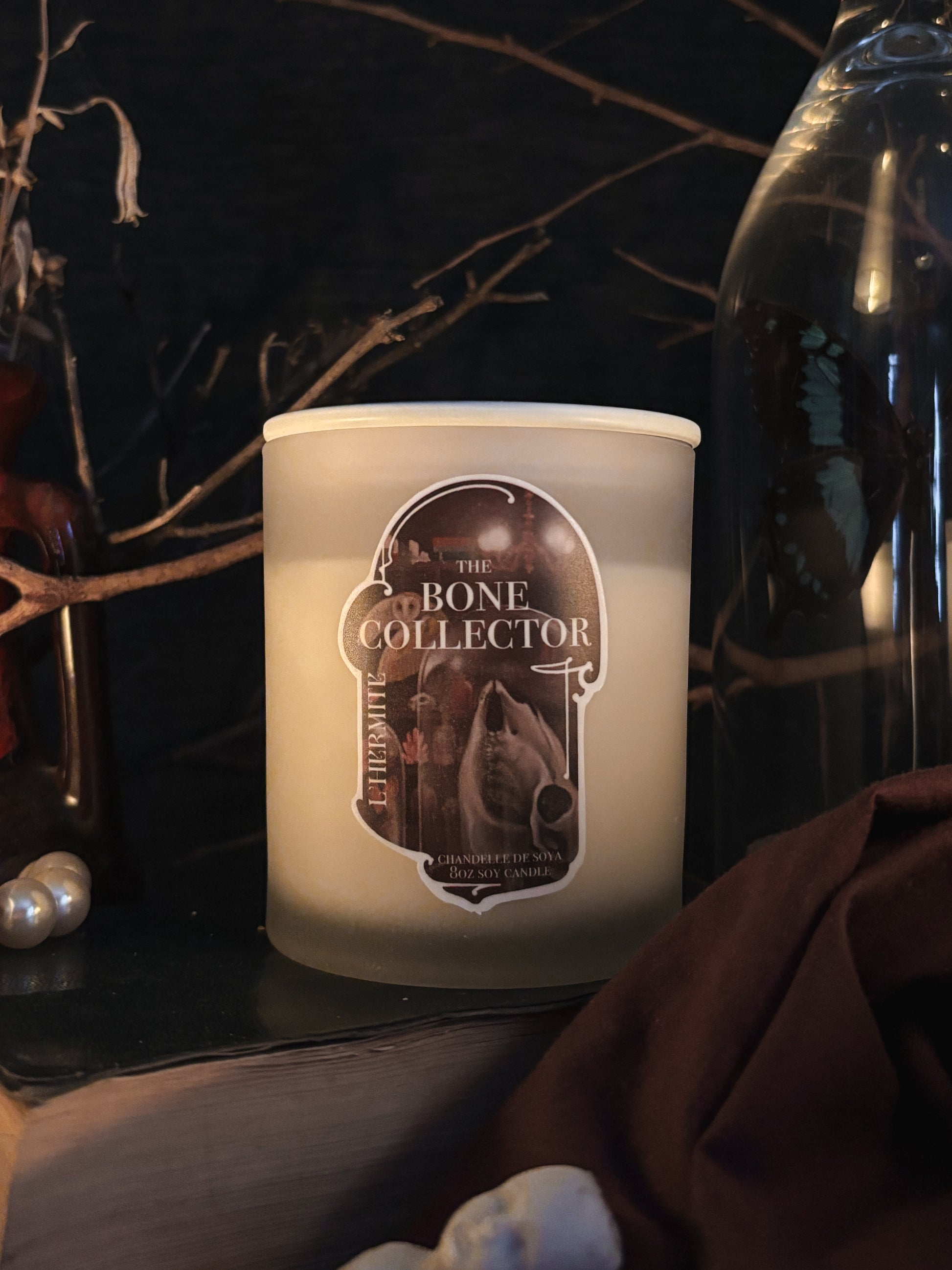 Candle labeled 'The Bone Collector' on a dark background