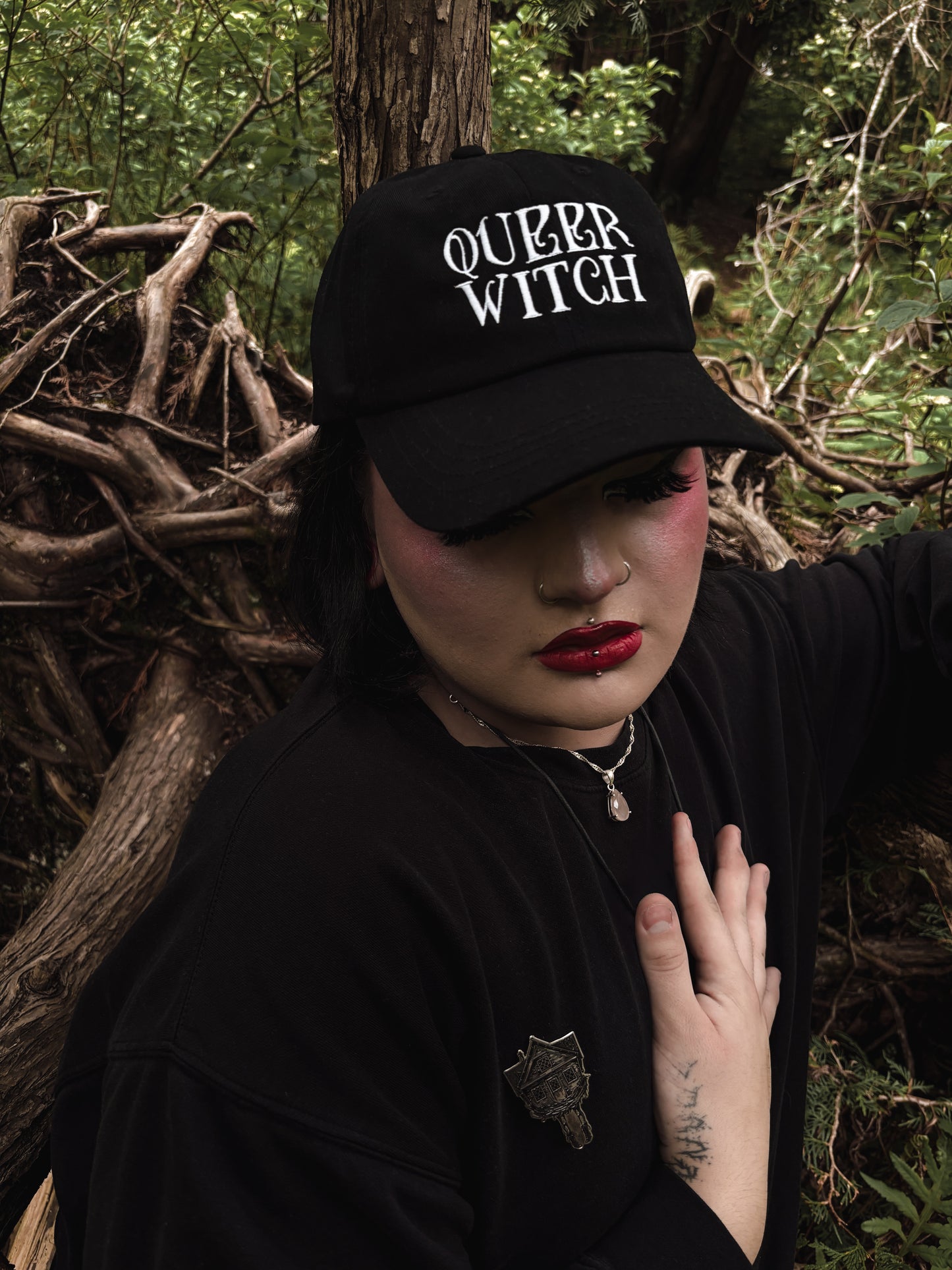 Black embroidered dad hat with 'Queer Witch' stitched in bold lettering. A perfect everyday spell for visibility.